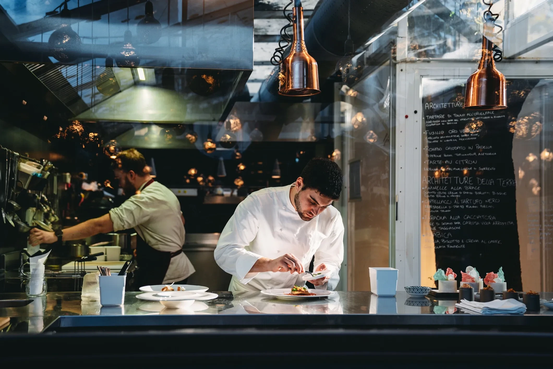 Professional chef plating in a luxury restaurant kitchen